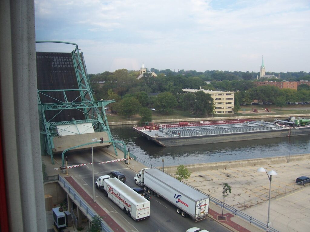 Vehicular bridge is up on the DesPlaines River to allow a barge through