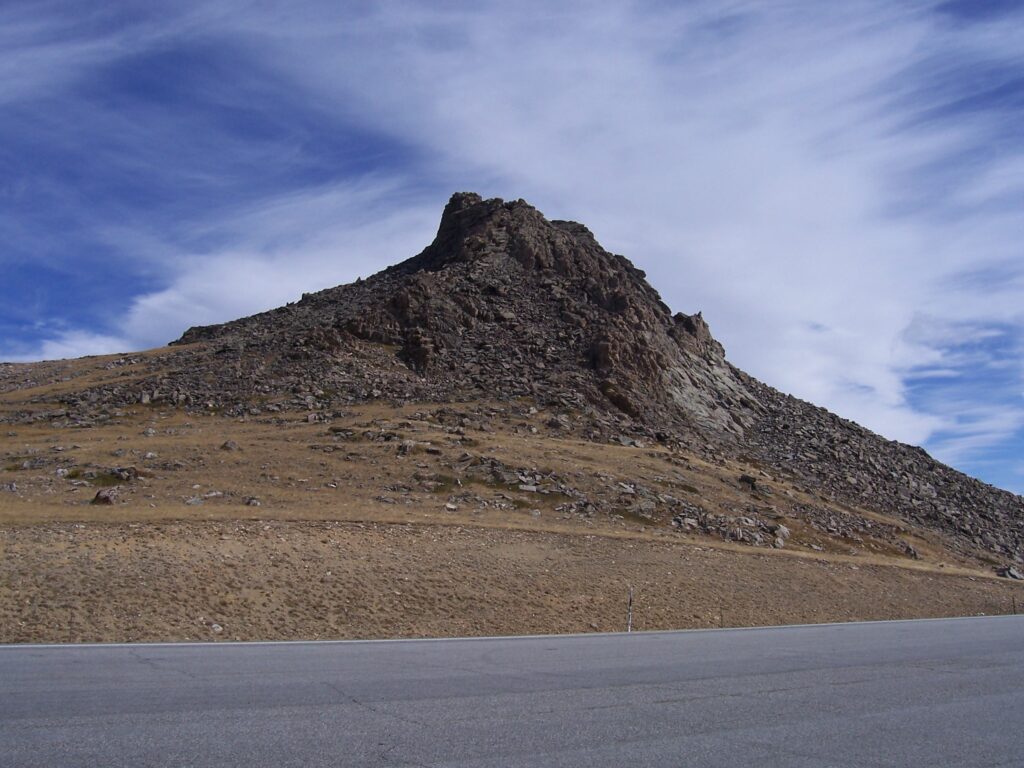 photo-rock-outcropping-under-wispy-clouds